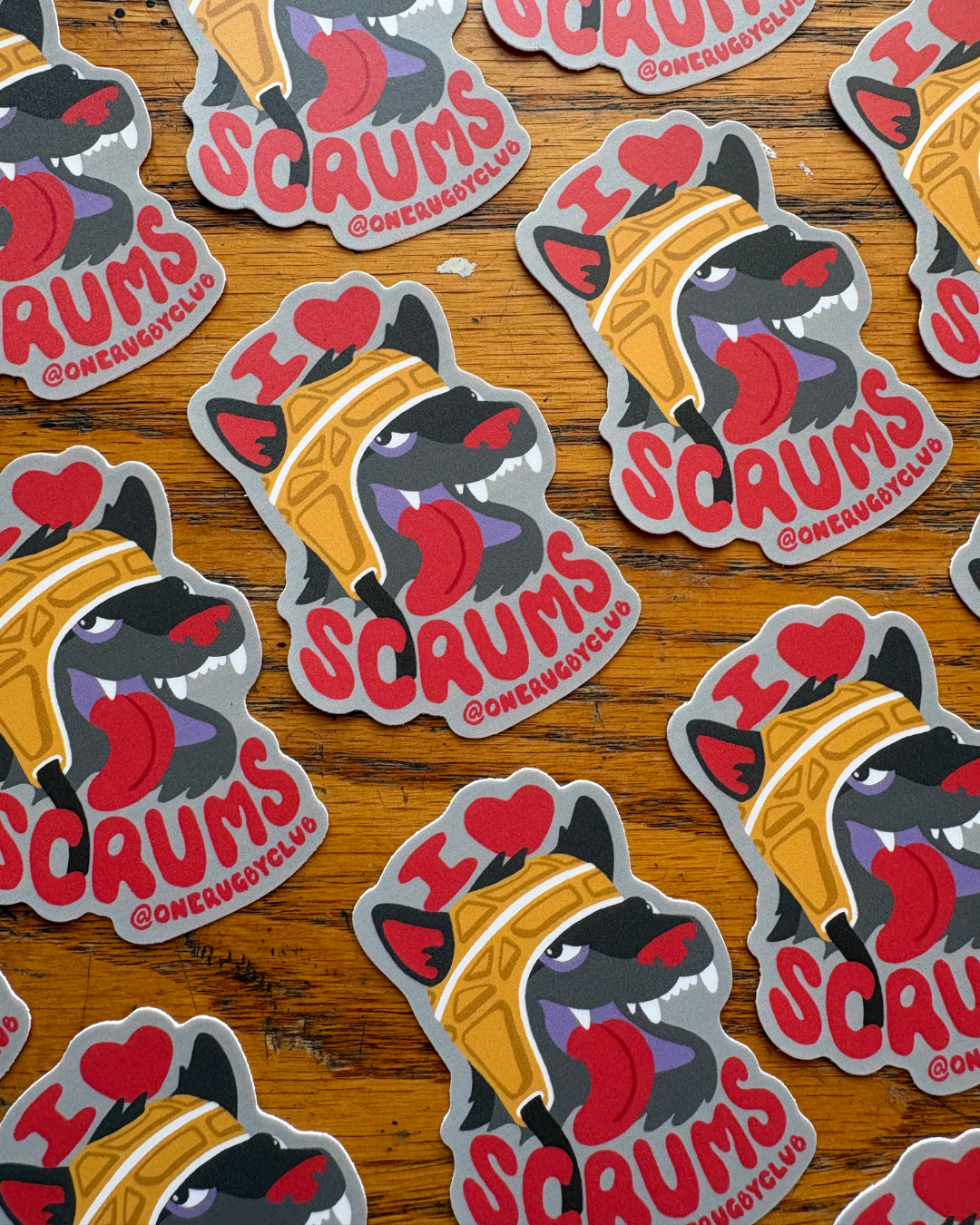 Repeating rows of stickers of a wolf in a scrum cap with the words "I love scrums"